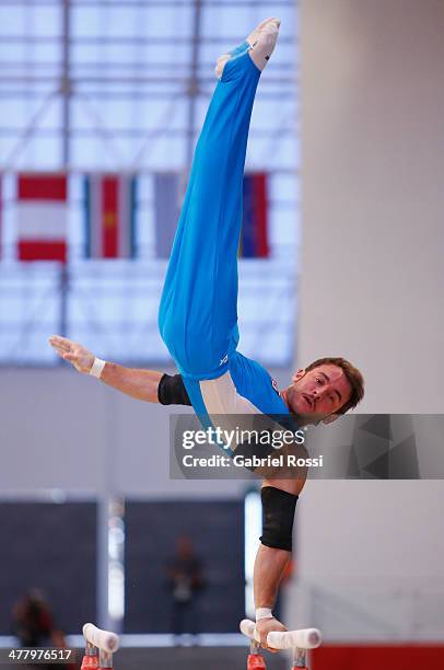 Tomas Gonzalez of Chile competes in the Mens Uneven Bars during day five of the X South American Games Santiago 2014 at Gimnasio Polideportivo...