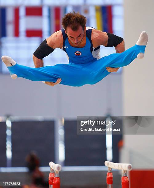 Tomas Gonzalez of Chile competes in the Mens Uneven Bars during day five of the X South American Games Santiago 2014 at Gimnasio Polideportivo...