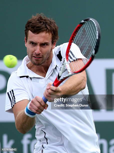 Ernests Gulbis of Latvia hits a return to Grigor Dimitrov of Bulgara during the BNP Paribas Open at Indian Wells Tennis Garden on March 9, 2014 in...