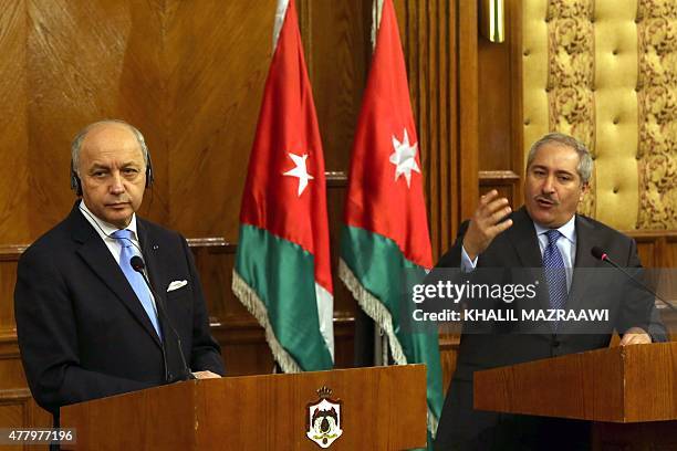 French Foreign Affairs minister Laurent Fabius listens as his Jordanian counterpart Nasser Judeh speaks during a joint press conference in the...