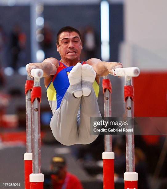 Jorge Giraldo of Colombia competes in the Men's Uneven Bars during day five of the X South American Games Santiago 2014 at Gimnasio Polideportivo...