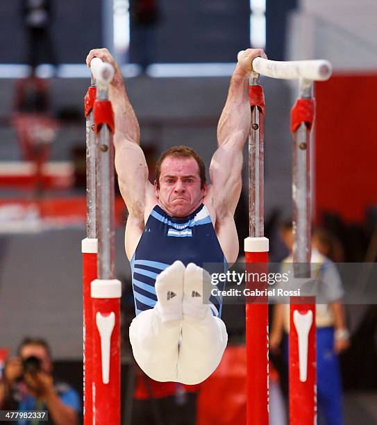 Osvaldo Martinez of Argentina competes in the Men's Uneven Bars during day five of the X South American Games Santiago 2014 at Gimnasio Polideportivo...