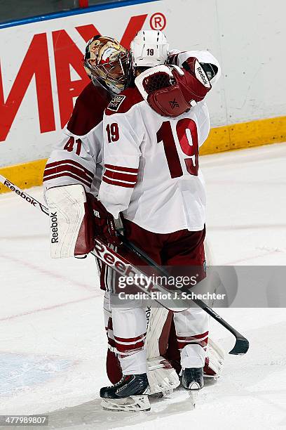 Goaltender Mike Smith of the Phoenix Coyotes hugs teammate Shane Doan after a 3-1 win against the Florida Panthers at the BB&T Center on March 11,...