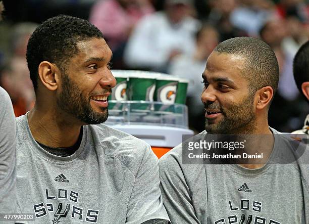 Tim Duncan and Tony Parker of the San Antonio Spurs enjoy a laugh while sitting on the bench during a game against the Chicago Bulls at the United...