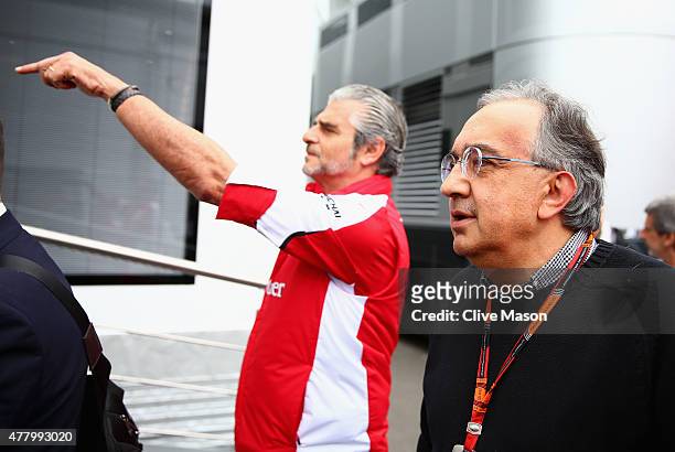 Ferrari Team Principal Maurizio Arrivabene speaks with Fiat CEO Sergio Marchionne in the paddock before the Formula One Grand Prix of Austria at Red...