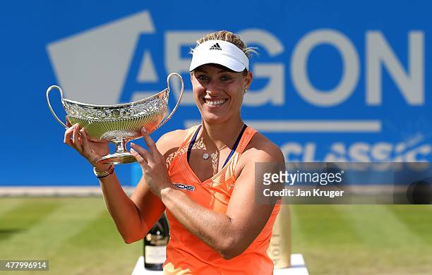 Angelique Kerber of Germany celebrates with the tyrophy after victory in her singles final match against Karolina Pliskova of Czech Republic on day...