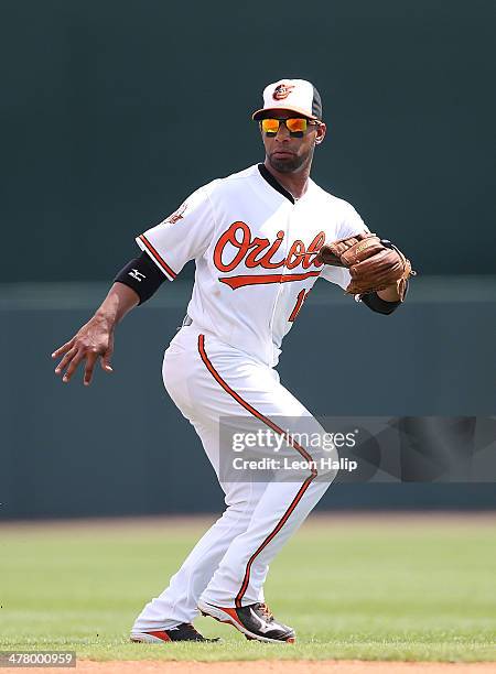 Alexi Casilla of the Baltimore Orioles gets ready to field the ground ball during the spring training game against the Boston Red Sox at Ed Smith...