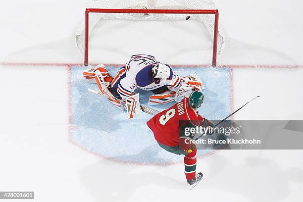 Mikko Koivu of the Minnesota Wild scores a shootout goal against Viktor Fasth of the Edmonton Oilers on March 11, 2014 at the Xcel Energy Center in...