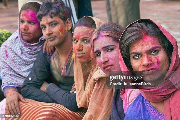 gay indian group watching holi festival - indian transgender stock pictures, royalty-free photos & images