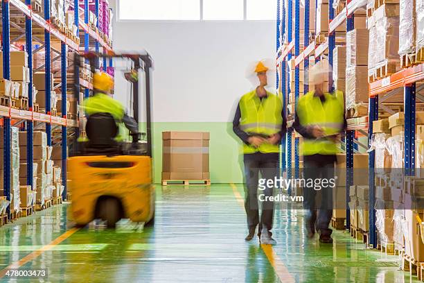 coworkers in warehouse - busy warehouse stock pictures, royalty-free photos & images