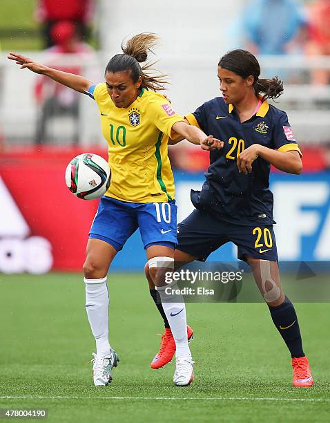 Marta of Brazil holds off Samantha Kerr of Australia during the FIFA Women's World Cup 2015 round of 16 match between Brazil and Australia at Moncton...