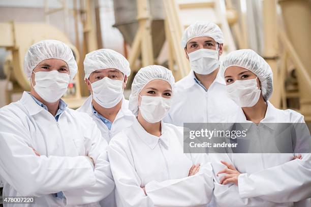 group of people working at a food factory - blue collar worker mask stock pictures, royalty-free photos & images