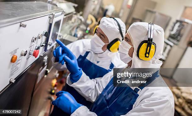 men operating machine at a food factory - hygiene stock pictures, royalty-free photos & images