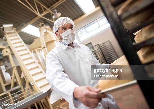 man working at a bakery - hair net stock pictures, royalty-free photos & images