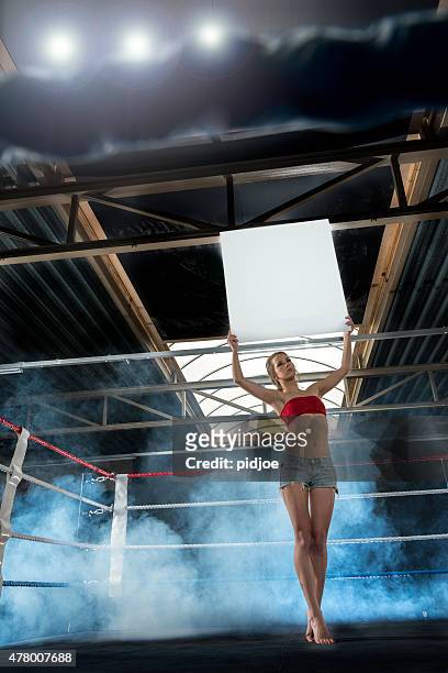 ring girl announcing start of round at box match - championship ring stockfoto's en -beelden