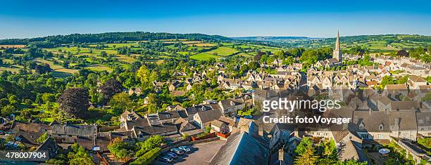 aerial panorama over idyllic country village cottages green summer fields - village stock pictures, royalty-free photos & images