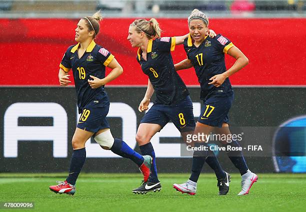 Kyah Simon of Australia celebrates with team mates Katrina Gorry and Elise Kellond-Knight as she scores their first goal during the FIFA Women's...