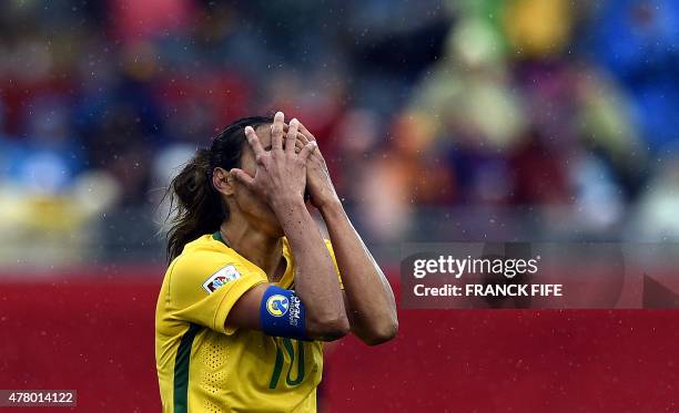 Brazil's midfielder Marta reacts to her teams' loss to Australia in their 2015 FIFA Women's World Cup round of 16 match at Moncton Stadium, in New...