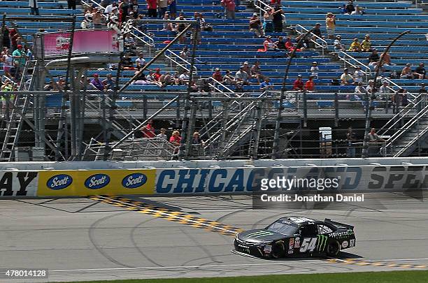 Erik Jones, driver of the Monster Energy Toyota, crosses the finish line to win the NASCAR XFINITY Owens Corning AttiCat 300 at Chicagoland Speedway...