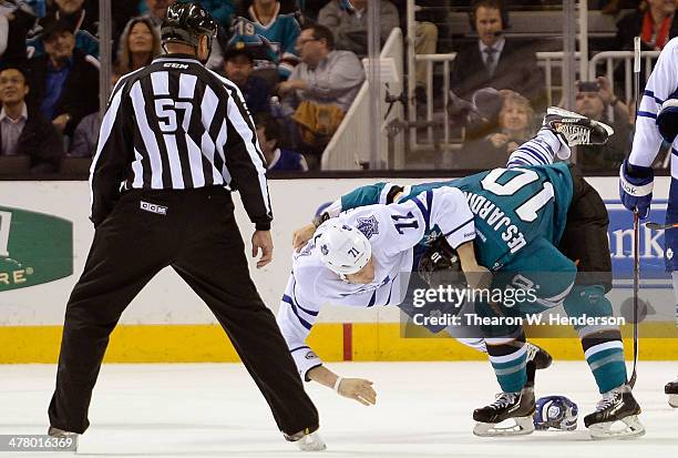 Andrew Desjardins of the San Jose Sharks and David Clarkson of the Toronto Maple Leafs fall to the ice while fighting during the second period at SAP...