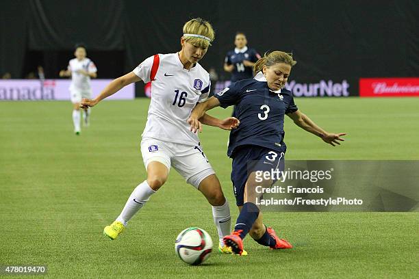 Laure Boulleau of France battle for the ball against Yumi Kang of Korea during the FIFA Women's World Cup Canada 2015 round of 16 match between...