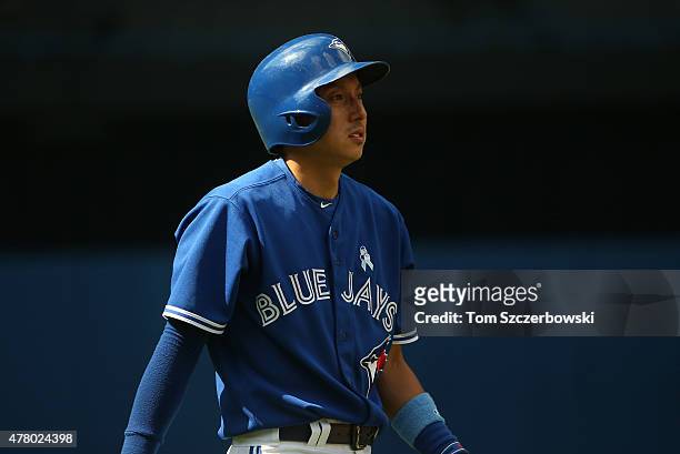 Munenori Kawasaki of the Toronto Blue Jays looks on after coming into the game as a pinch runner in the eighth inning during MLB game action against...