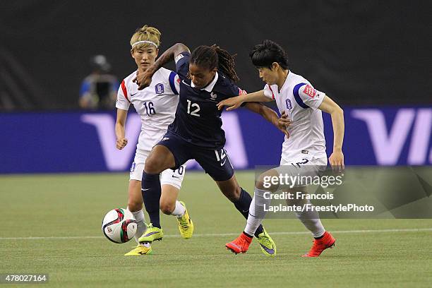 Elodie Thomis of France controls the ball against Eunmi Lee and Yumi Kang of Korea during the FIFA Women's World Cup Canada 2015 round of 16 match...