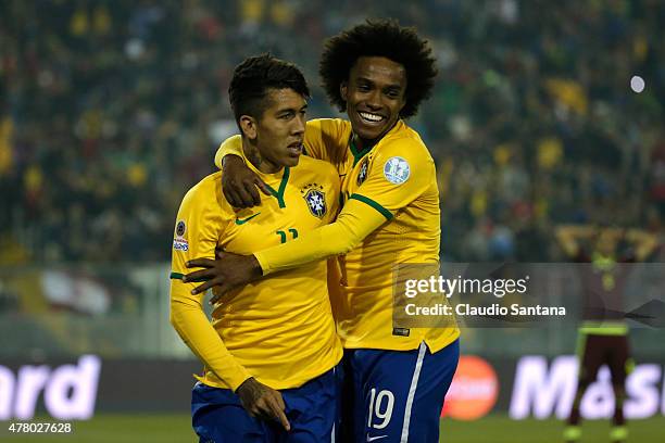 Roberto Firmino of Brazil celebrates with teammate Willian after scoring the second goal of his team during the 2015 Copa America Chile Group C match...