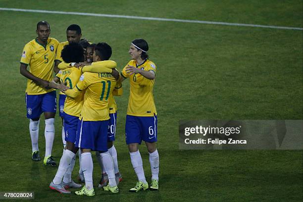 Roberto Firmino of Brazil celebrates with teammates after scoring the second goal of his team during the 2015 Copa America Chile Group C match...