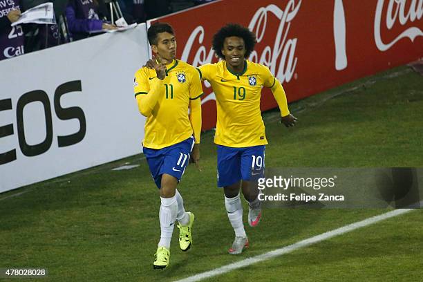 Roberto Firmino of Brazil celebrates with teammate Willian after scoring the second goal of his team during the 2015 Copa America Chile Group C match...