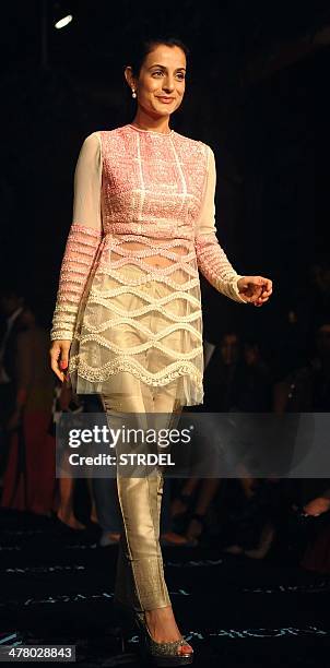 Indian Bollywood actress Ameesha Patel poses for a photograph on the first day of the Lakme Fashion Week Summer/Resort 2014 in Mumbai on late March...