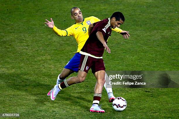 Diego Tardelli of Brazil fights for the ball with Roberto Rosales of Venezuela during the 2015 Copa America Chile Group C match between Brazil and...