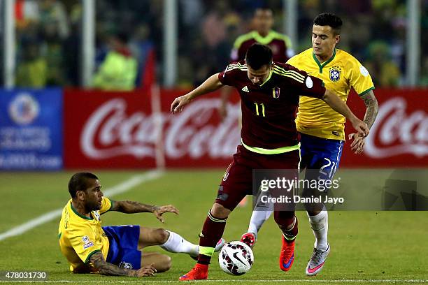 Cesar Gonzalez of Venezuela fights for the ball with Dani Alves and Philippe Coutinho of Brazil during the 2015 Copa America Chile Group C match...
