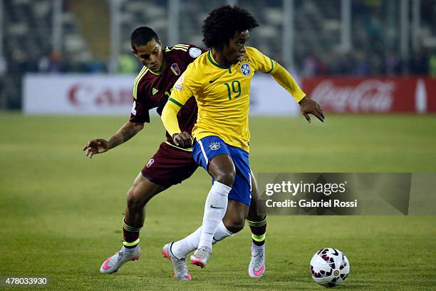 Willian of Brazil fights for the ball with Roberto Rosales of Venezuela during the 2015 Copa America Chile Group C match between Brazil and Venezuela...