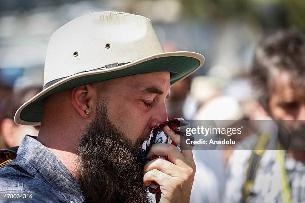 People gather in front of the Emanuel AME Church to attend the first mass after the gunman shooting attack, left nine dead on June 21 in Charleston,...