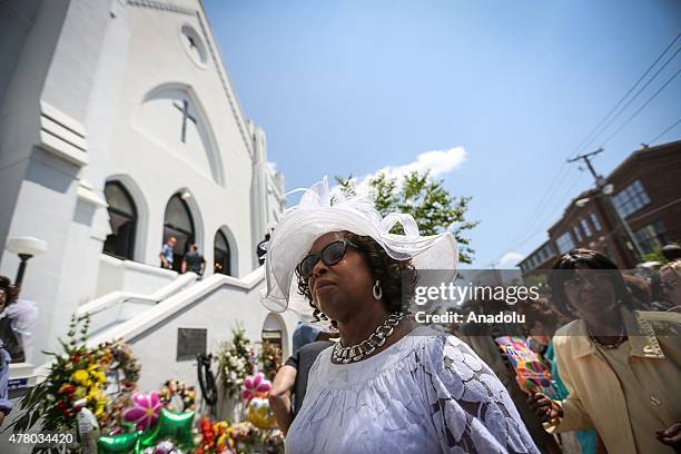 People gather in front of the Emanuel AME Church to attend the first mass after the gunman shooting attack, left nine dead on June 21 in Charleston,...