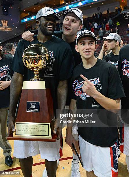 Sam Dower, Przemek Karnowski and David Stockton of the Gonzaga Bulldogs pose on the court with the trophy after winning the championship game of the...