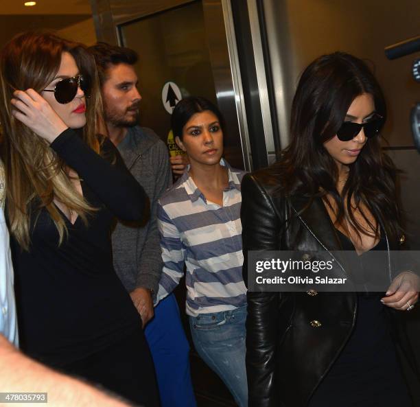 Khloe Kardashian, Scott Disic, Kourtney Kardashian and Kim Kardashian are seen on on March 11, 2014 in Miami Beach, Florida.