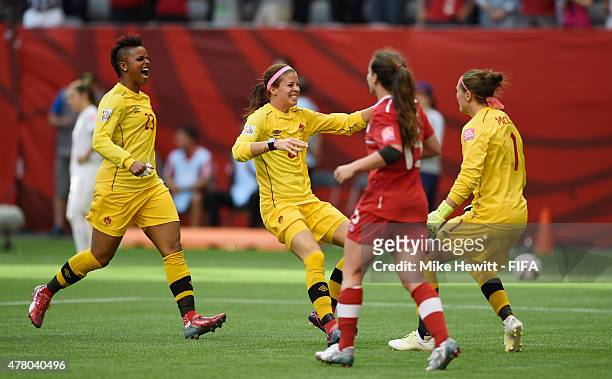 Reserve goalkeepers Stephanie Labbe and Karina LeBlanc rush to clebrate with Erin McLeod of Canada at the end of the FIFA Women's World Cup 2015...