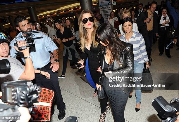 Khloe Kardashian, Kim Kardashian and Kourtney Kardashian are seen on March 11, 2014 in Miami, Florida.