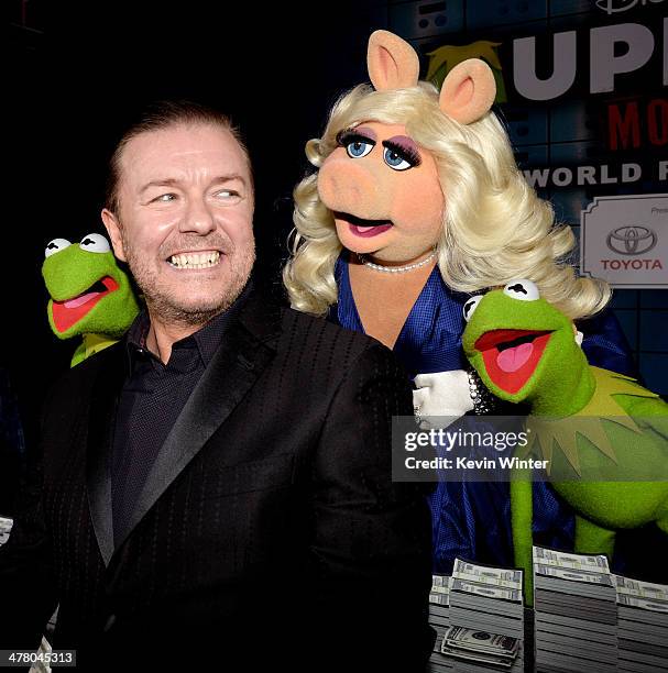 Actor Ricky Gervais, with Constantine, , Miss Piggy and Kermit the Frog pose at the premiere of Disney's "Muppets Most Wanted" at the El Capitan...