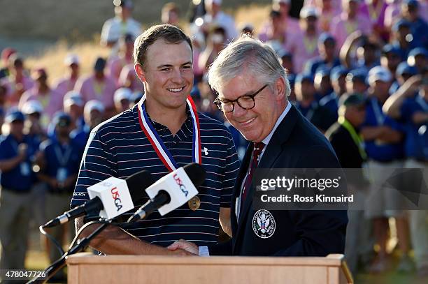 Jordan Spieth of the United States poses with the trophy alongside Thomas O'Toole, Jr., President of the USGA after Spieth won the 115th U.S. Open...