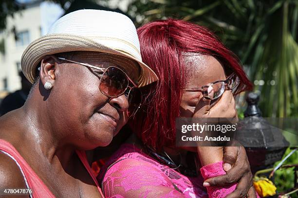 People gather in front of the Emanuel AME Church to attend the first mass after the gunman shooting attack, left nine dead on June 21 in Charleston,...