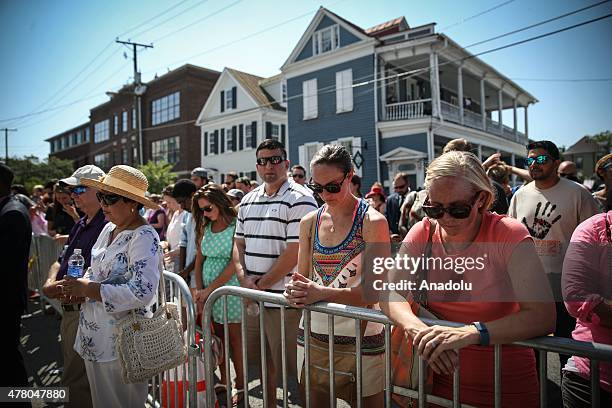 People gather in front of the Emanuel AME Church to attend the first mass after the gunman shooting attack, left nine dead on June 21 in Charleston,...