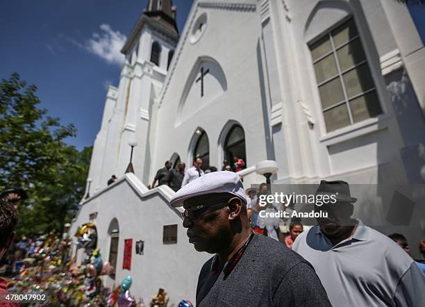 People gather in front of the Emanuel AME Church to attend the first mass after the gunman shooting attack, left nine dead on June 21 in Charleston,...