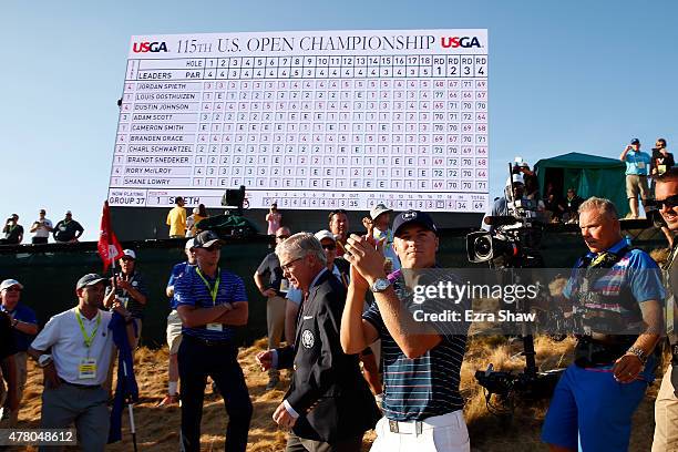 Jordan Spieth of the United States walks alongside Thomas O'Toole, Jr., President of the USGA, after Spieth won the 115th U.S. Open Championship at...