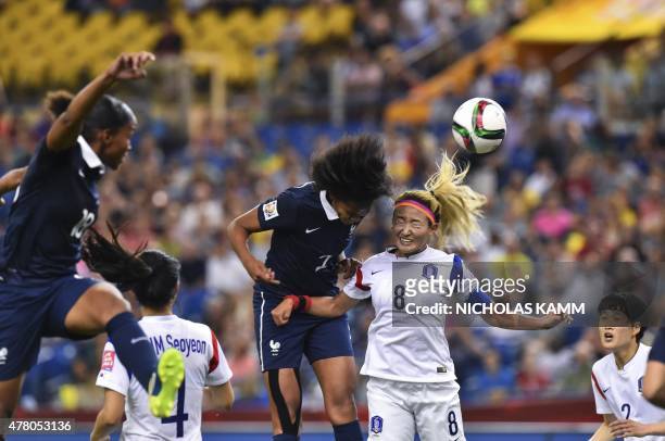 France's Wendie Renard and South Korea's Cho Sonhyun fight for the ball during a 2015 FIFA Women's World Cup round of 16 match at the Olympic Stadium...