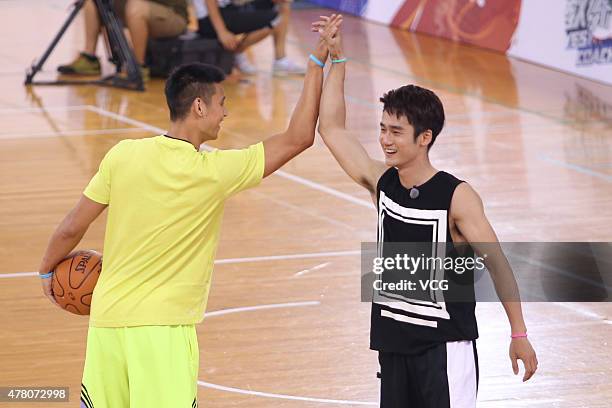 Jeremy Lin of Los Angeles Lakers plays basketball with children during Shanghai Dragon Television's show 'Yes! Coach' taping at Beijing Olympic...