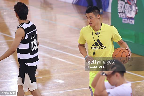 Jeremy Lin of Los Angeles Lakers plays basketball with children during Shanghai Dragon Television's show 'Yes! Coach' taping at Beijing Olympic...