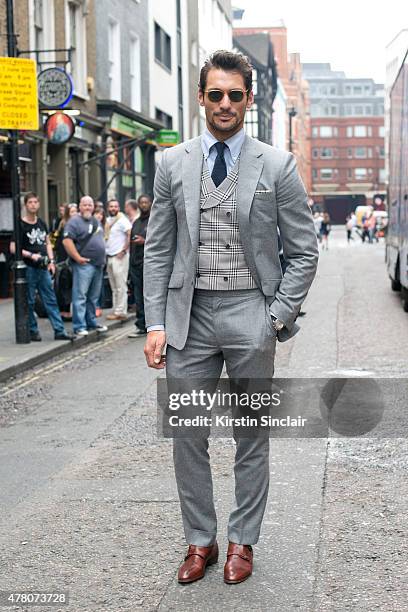Model David Gandy wears Marks and Spencer suit, shirt, tie and waistcoat, David Preston shoes, London Sock Company socks and Garrett Leight...
